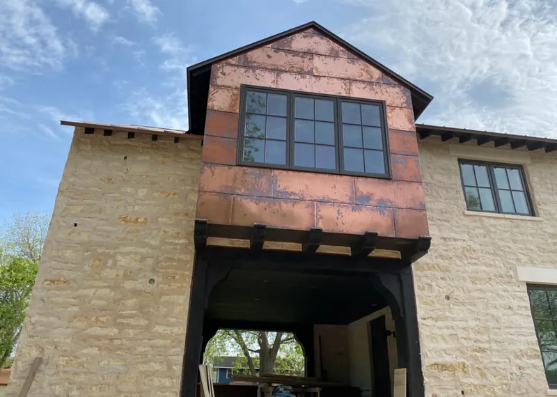 Copper metal panel facade on a stone building for Skylight Installation in Maple Valley